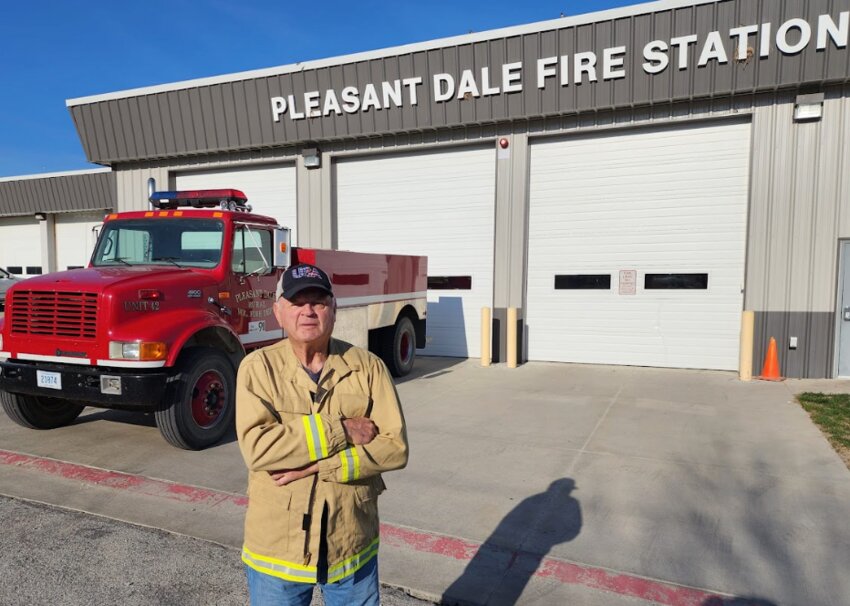 Pleasant Dale volunteer firefighter Larry Lawton stands in front of his favorite fire truck to operate, Unit 42.