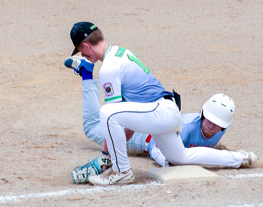 Cale Gardiner of Seward catches a throw at first but doesn't get the tag down against Wahoo July 19 in the state championship game.