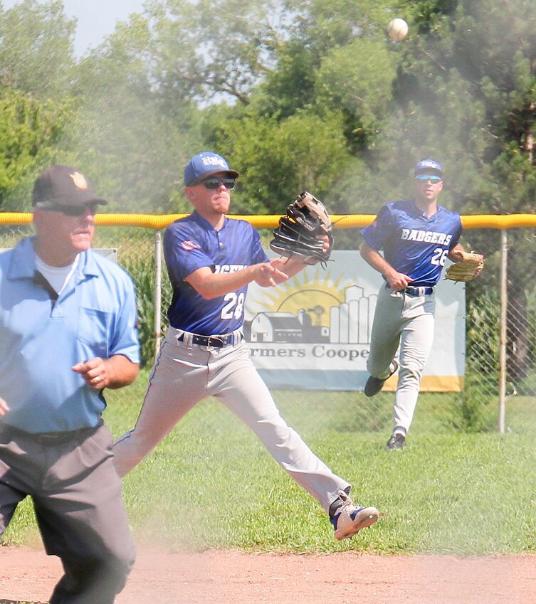 Connor Clouse of the Utica/Beaver Crossing/Friend Legion seniors leaves his feet to make the throw to first as teammate Shawn Rathjen backs up the play July 22 against David City.