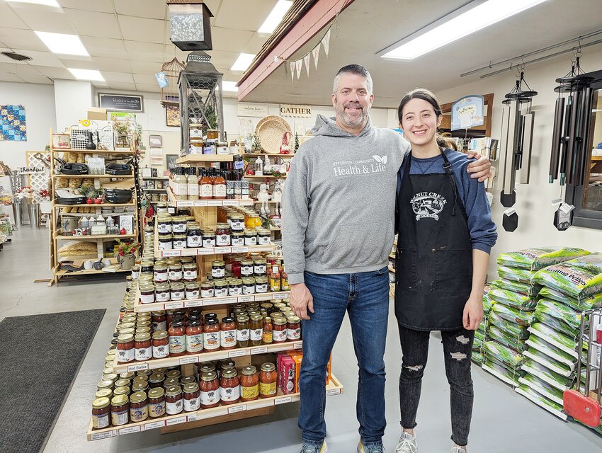 Craig Bontrager, owner of Main Street Market in Milford, stands with his youngest daughter, Celia, who plans to take over the store someday.
