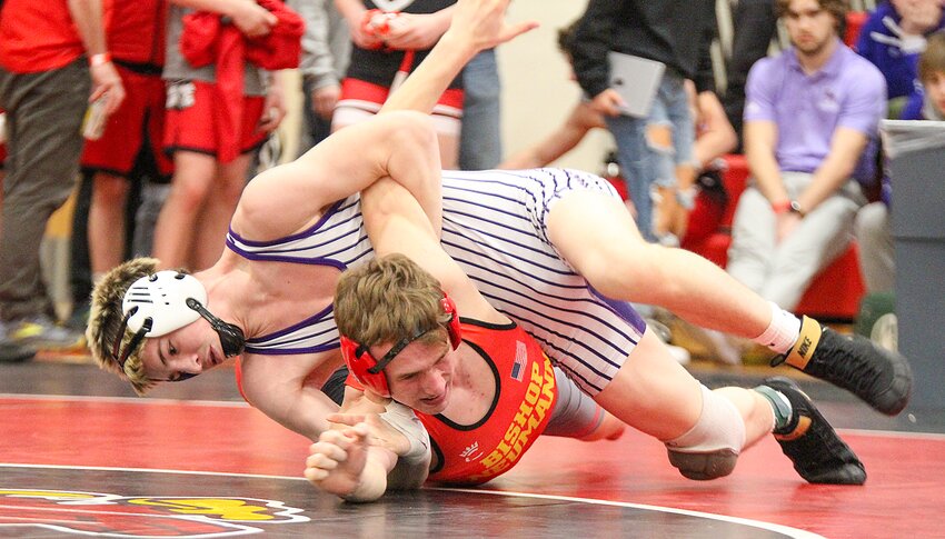 Kellen Lovitt of Milford scores nearfall points against Sean Shultz of Raymond Central in the third-place match at districts Feb. 10.