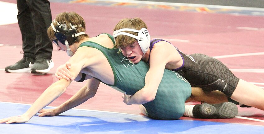Quinn Zegers of Milford turns Francisco Juan Lucas of Madison in their first-round consolation match.