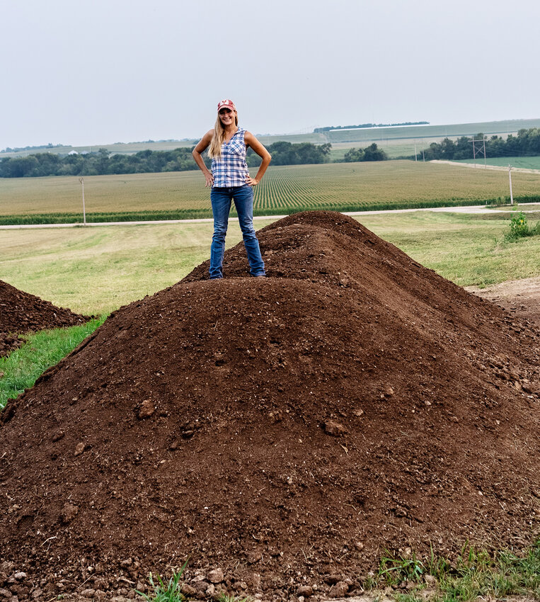 Angela Shukar stands on top of some of the Geocharged is an organic fertilizer that is made with nutrient-rich chicken manure compost.