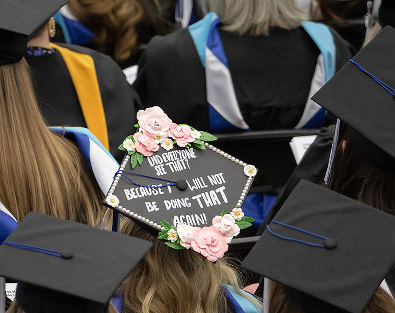 A decorated cap stands out as its wearer and other Concordia University seniors go through the university's 117th commencement exercise May 4.