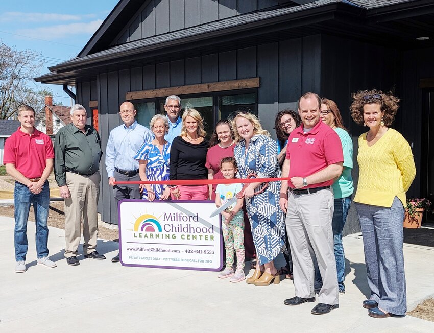 The Milford Childhood Learning Center cuts the ribbon on its new facility May 5. Pictured are, from left: Jacob Jennings, vice president and community affairs director for the Seward County Chamber and Development Partnership; Rev. Tim Springer and Dr. Brandon Henley, MCLC board members; Kathi Schildt, MCLC interim director, Dave Welsch and Katie Spohn, MCLC board members; Sami Ahlers, preschool teacher; Hayden Lacey, official ribbon cutter; Kylie Schildt, MCLC project manager; Tori Wergin, teacher; Jonathan Jank, president and CEO of the SCCDP; Kim Stauffer, infant teacher; and Sen. Jana Hughes, District 24.