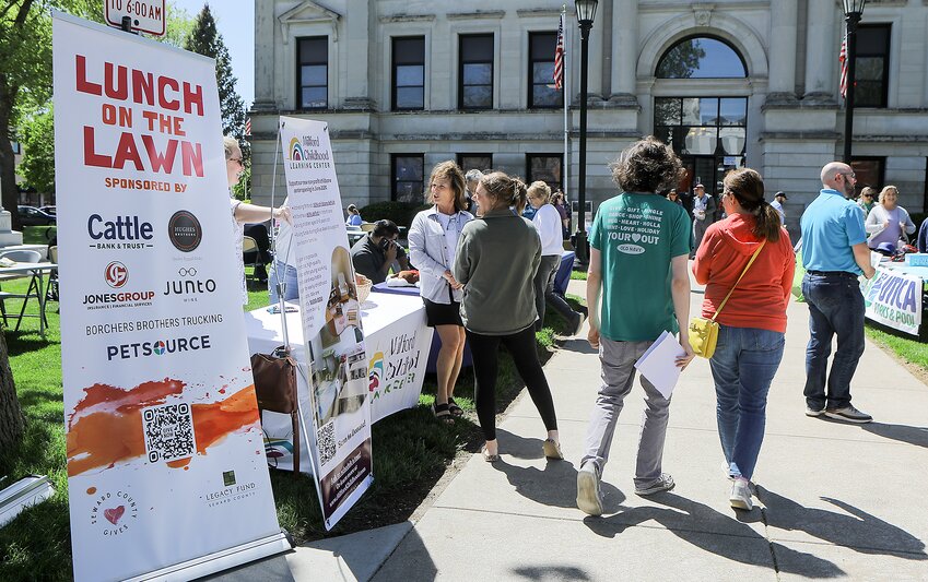 Participants in the Lunch on the Lawn event held May 7 outside the Seward County Courthouse cover the sidewalk as they visit various displays set up outside the courthouse.