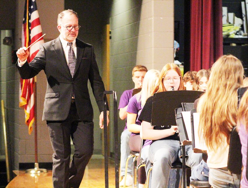 Phil Goddard steps back onstage to direct the close of a piece by the Milford High School band during the Celebration of Performing Arts on May 9. An endowed scholarship has been created in Goddard’s name to recognize his 23 years of directing the bands at Milford.