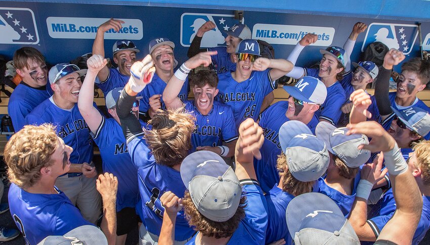 Members of the Malcolm baseball team celebrate their state championship in the dugout following their 3-2 come-from-behind victory over Mount Michael Benedictine.