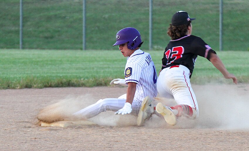 Caleb Kempf of Milford slides past the ETC second baseman, who dives after the ball, and is safe with a stolen base.