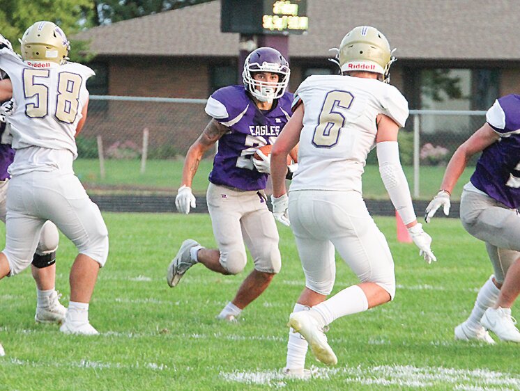 Tyce Lopez of Milford looks for an opening in the defense against Louisville Sept. 6. Lopez and the Eagles trailed at haltfime but came back to win the game 21-10.