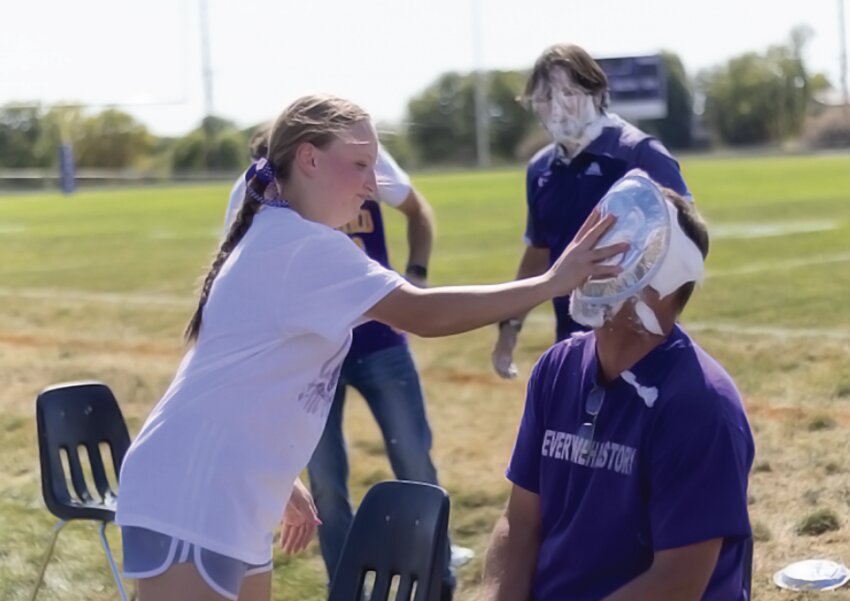 Milford senior Brenna Jackson gets her chance at “pieing” Mr. Wissenburg during the Homecoming Pep Rally.