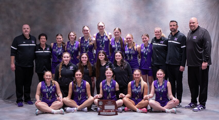 Members of the Milford girls’ basketball team pose with their runner-up trophy after the Class C1 championship game March 8. They include, from left: (first row) Karlee Kuklis, Izzy Yeackley, Ayla Roth, Taylor Oldfield and Kylie Jakub; (second row) Cora Klopfenstein, Violet Augustyn, Brianna Meierdierks and Addison DeLong; and (third row) Coaches Greg Miller and Michele Kontor, Adalyn Cisneros, Abby Crabtree, Ashlynn Miller, Shayla Rautenberg, Braelynn Muller, Maeli Kubicek, Kenzie Jakub and Coaches Kennedy Mogul, Bryce Roth and Brett Muller.