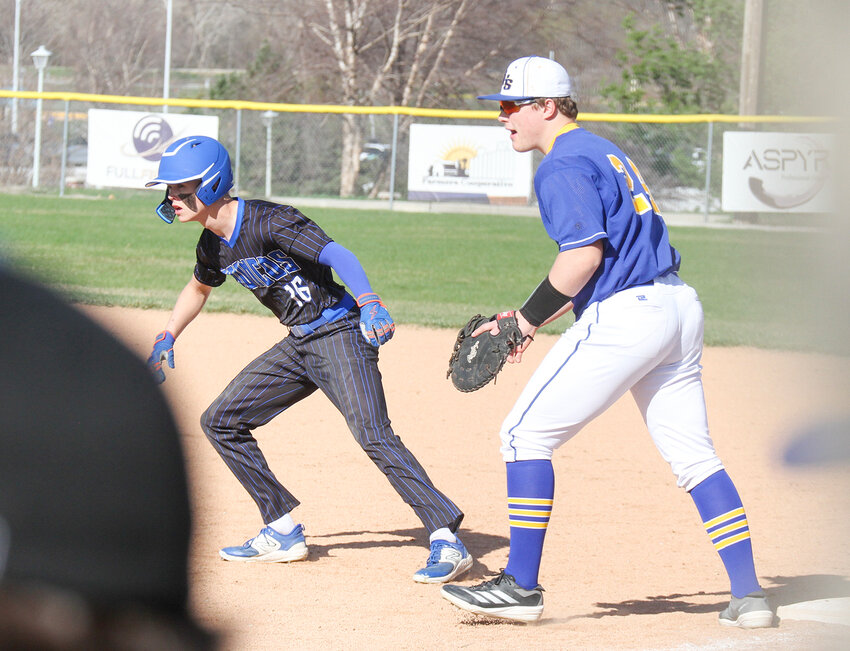 Centennial's Cooper Stelling leads off first as Kyle Riley of Seward moves into defensive position April 10. Seward defeated Centennial 12-2.