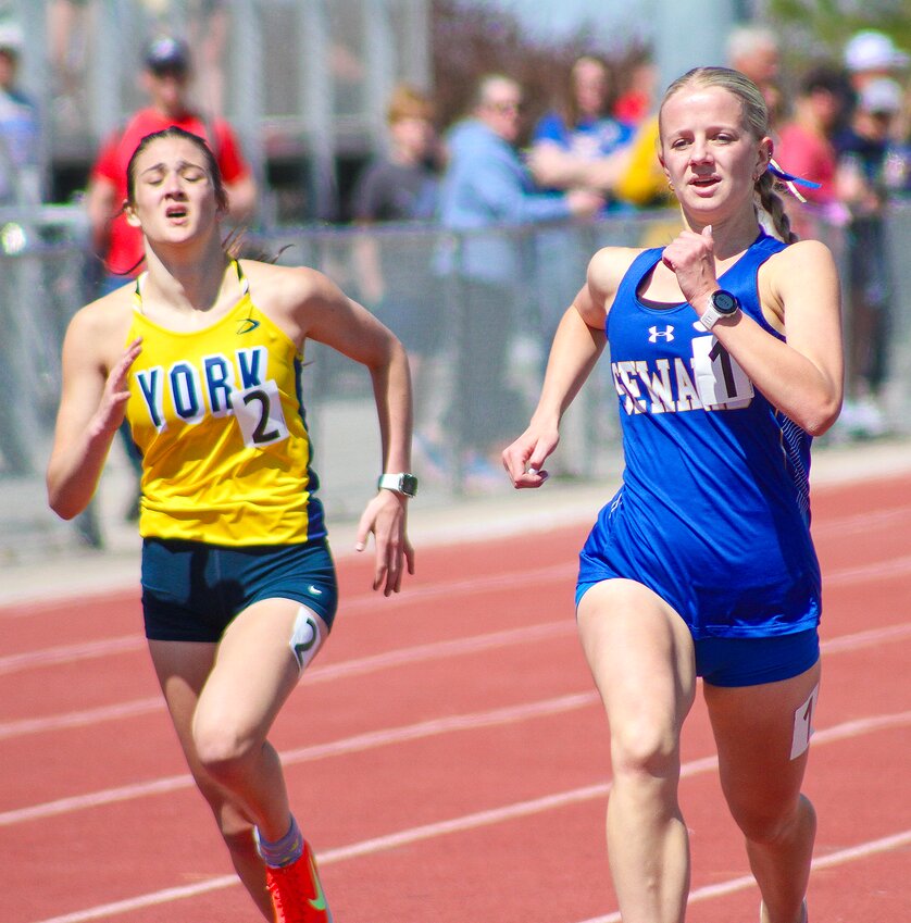 Brianna Potratz of Seward keeps her eyes on the runner in front of her during the girls 4X800m relay on April 11.