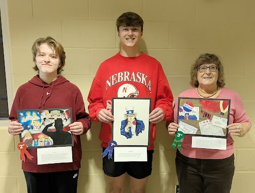 The Seward VFW Post 4755 Young American Creative Patriotic Art Contest was conducted in early April. Students who studied art at Seward High School had entries that were judged at that time. The first-place entry moves on to the VFW state convention, where it will be judged among other entries in the state. There were 21 entries on the local level and those students that placed in the contest as shown in the picture, are (MIDDLE) Tylan Wohlford of Seward, first place; (LEFT) Adleigh Popple of Seward, second place; and (RIGHT) Art Chair Joan Pearson holding the work of Jena Eberspacher of Beaver Crossing, third place.