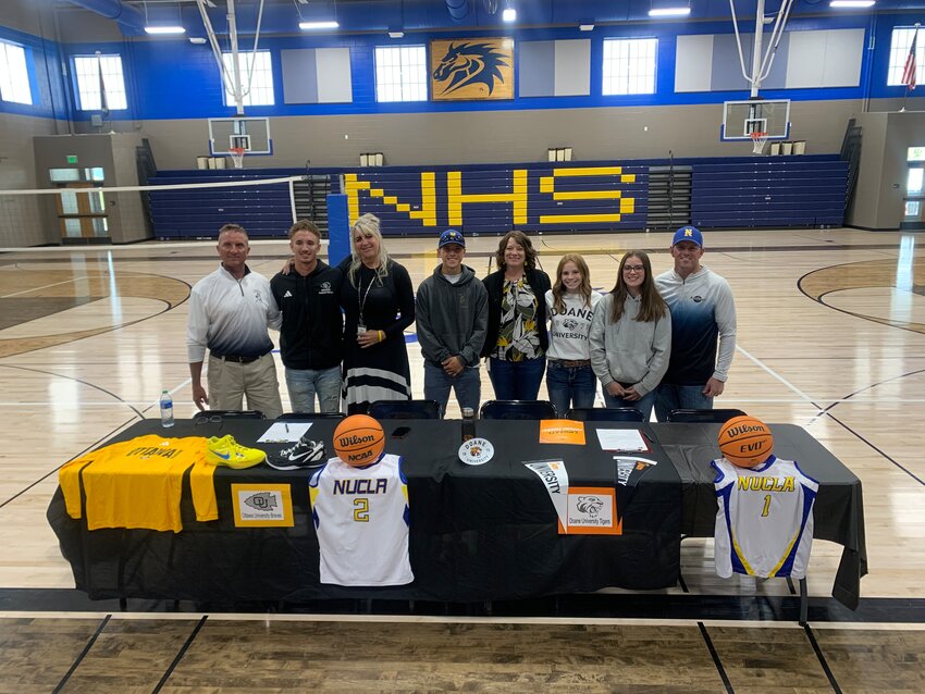 Steele Arnold with family, left, and Keiran Bray with family, right, attend their college commitment signings in Nucla last week.