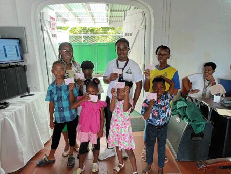 Children at the Hoggard A.M.E. Zion Church, Barbados showing off their certificate vouchers.