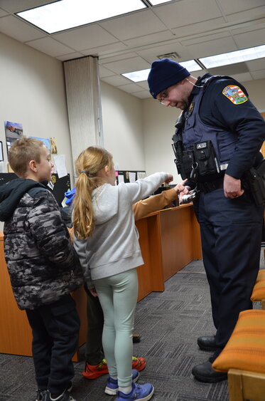 A group of kids point to Foley police officer Alex Skluzacek’s vest to ask about his equipment Feb. 15 in Foley. Foley Police Chief Katie McMillin said the department has hosted the Fun with the Foley Police Department event for nearly a decade.