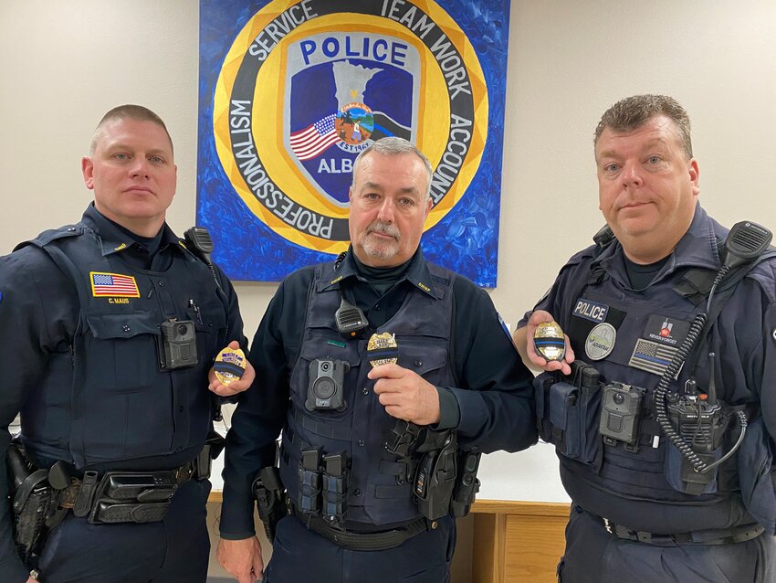 Melrose Police Chief Craig Maus (from left), Albany Police Chief Ozzie Carbajal and Avon Police Chief Corey Nellis display mourning bands on their badges Feb. 23 at the Albany Police Department in Albany. The bands are in memory of the three first responders who died following a Feb. 18 domestic incident call in Burnsville.