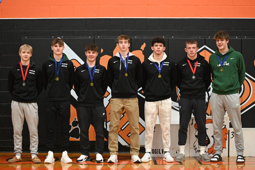 The Holdingford High School wrestling state qualifiers — Wyatt Novitzki (from left), Masyn Patrick, Will Pilarski, Drew Lange, Luke Bieniek, Kolton Harren and Jaxon Bartkowicz — receive their Section 7A medals Feb. 23 at Ogilvie High School in Ogilvie. The Huskers are sending seven wrestlers to the Minnesota State High School League Class A Wrestling State Tournament for the second season in a row.