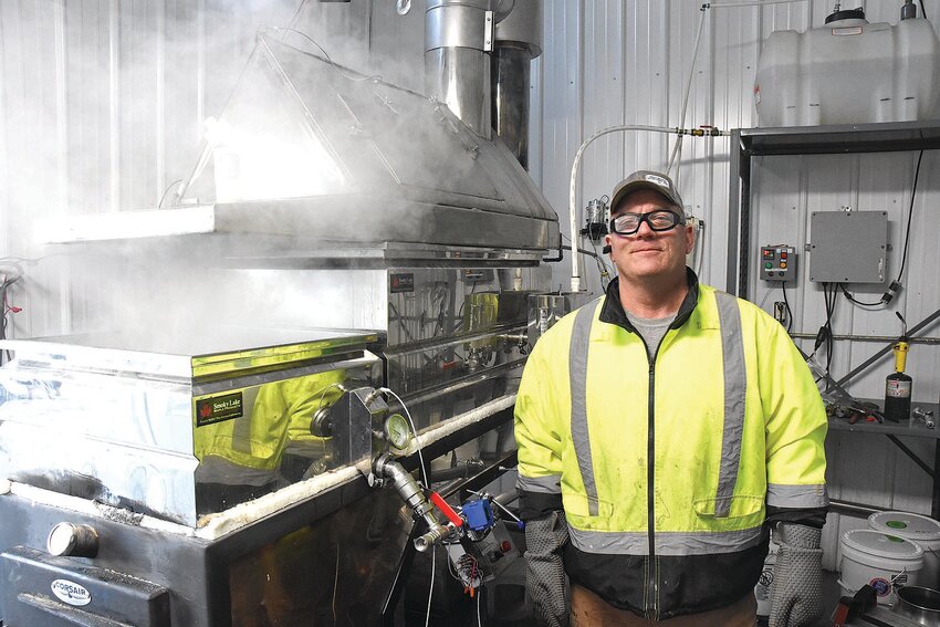 Steam pours from Mike Lensing’s evaporator as he makes syrup Feb. 22 in Ward Springs. Lensing began cooking the first weekend in February, the earliest he has ever started.