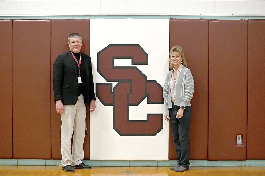 Don Peschel (left), Sauk Centre Public Schools superintendent, and Lisa Otte, Holy Family School principal, visit April 10 at Sauk Centre High School in Sauk Centre. The two administrators are longtime friends who graduated from the high school as members of the class of 1985.
