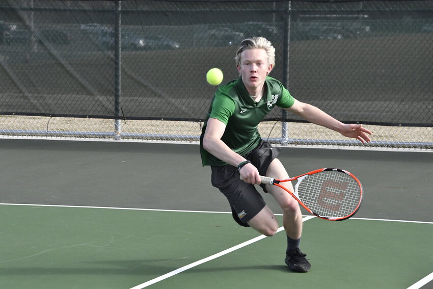 Storm senior Trace Nelson lunges for a one-handed backhand during his No. 4 singles match against Willmar April 11 at Sauk Rapids-Rice High School in Sauk Rapids. Nelson lost his match in straight sets.