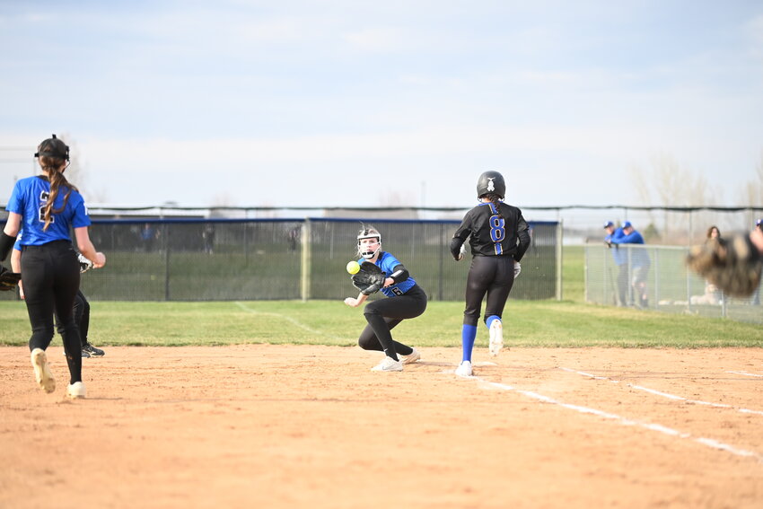 Claudia Chmielewski watches a throw from pitcher Josi Pozorski into her glove for a putout April 15 at Foley High School in Foley. Chmielewski and the Falcons made several big defensive plays but could not slow down Cathedral in a 13-0 loss.