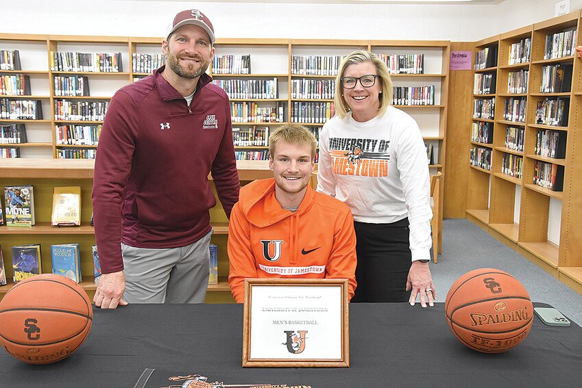 Jay Neubert, pictured with his parents Aaron Neubert and Ann Hess, has committed to play basketball at the University of Jamestown, as the Sauk Centre High School senior signed his letter of intent April 23 in Sauk Centre. 
Neubert put together a historic career for the Sauk Centre boys basketball team; as a five-year starter and three-time captain, he holds the program’s all-time scoring mark with 2,567 points, and he is the school’s career points-per-game leader. He also made more 3-pointers than any Streeters before him. 
The dazzling guard’s impact on the court was also noticed by his competition. Neubert was a West Central All-Conference selection on five  occasions, and was twice named the conference’s MVP. He also was a four-time All-Section 6AA player and was honored with an All-State nod this past season.