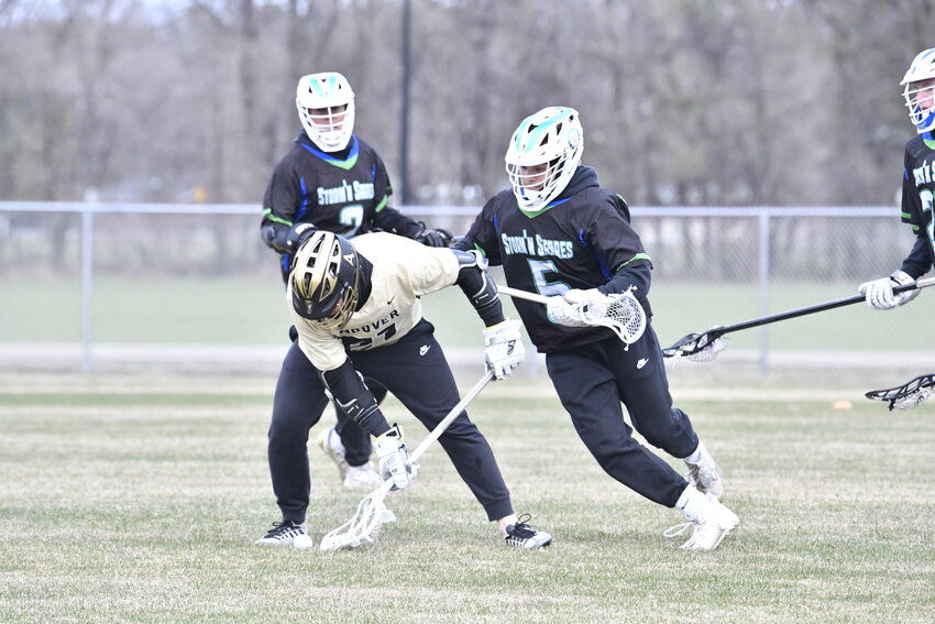 Storm’n Sabres sophomore Will Corrieri tries knocking an Andover player off the ball in the home-opening game April 19 at the Sartell High School fields in Sartell. The Huskies used a seven-goal first half and held on for an 11-7 victory over Sauk Rapids-Rice/Sartell.