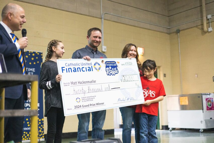 Avery (from left), Matthew, Linsey and Reed Hackenmueller hold a novelty check representing a $20,000 grand prize through the Catholic United Financial Raffle April 19 at St. John’s Area School in Foley. The raffle raised more than $1.4 million in 2024, according to a Catholic United Financial press release.