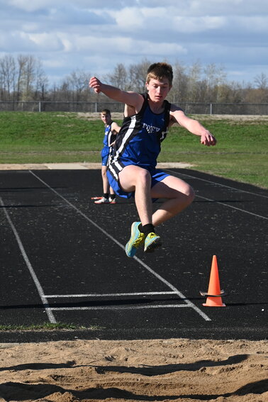 Jakob Buerger goes airborne during the long jump April 22 at Foley High School in Foley. Buerger soared to a 16-foot, 3-inch result, taking 16th place in the event at the Falcons’ home Granite Ridge Conference meet.