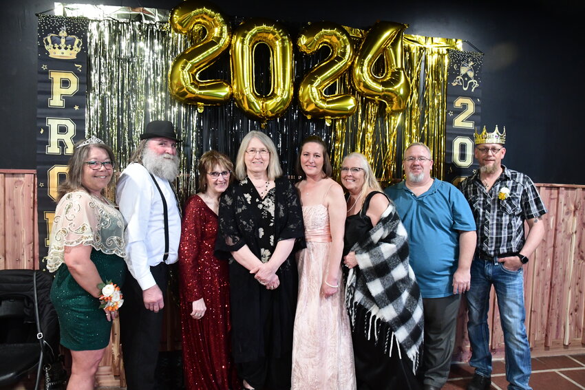 Jennifer Brickweg (from left), John Engst, Barb Nathe, Joan Zierden, Aimee Gerads, Jane Schleicher, Bob “Bullet” Kranz and Bryan Brickweg gather for a traditional photo April 20 during the 20th adult prom at Hot Shots Bar & Grille in New Munich. Most attended the first prom in 2004.