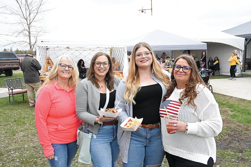 Veronica Monti (from left), Addie Verant, Emma Olivia Hicks and Dawn Myhre pick up food during the Sauk Centre Area Chamber of Commerce Spring Out & Designer Bag Bingo event April 27 at The Shed north of Sauk Centre. Hicks flew in from Tucson, Arizona, to be with her family at the event.