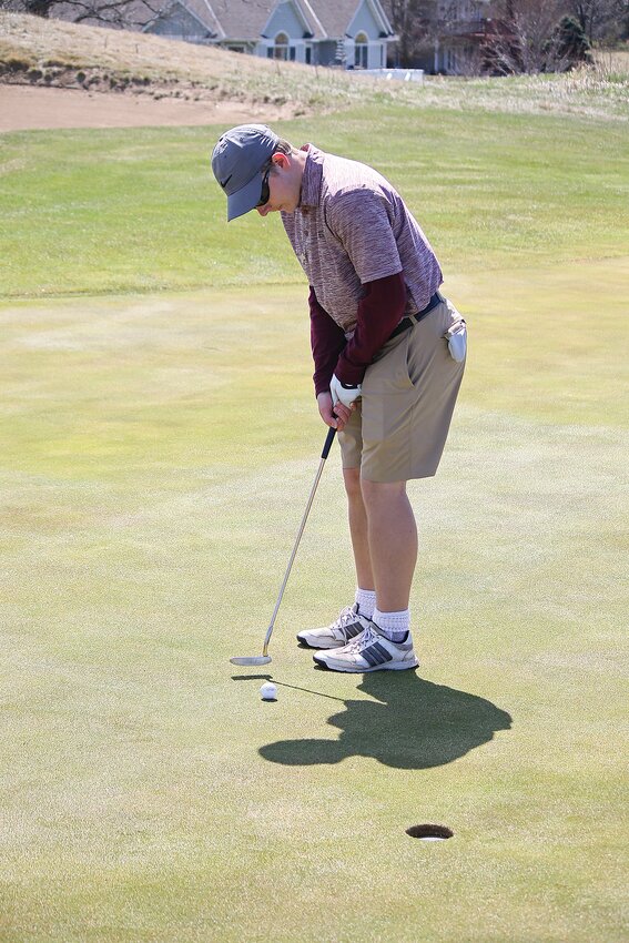 Christopher Polipnick taps the ball to the cup April 30 in the West Central Conference meet at Meadowlark Country Club in Melrose. Sauk Centre finished with a 192.
