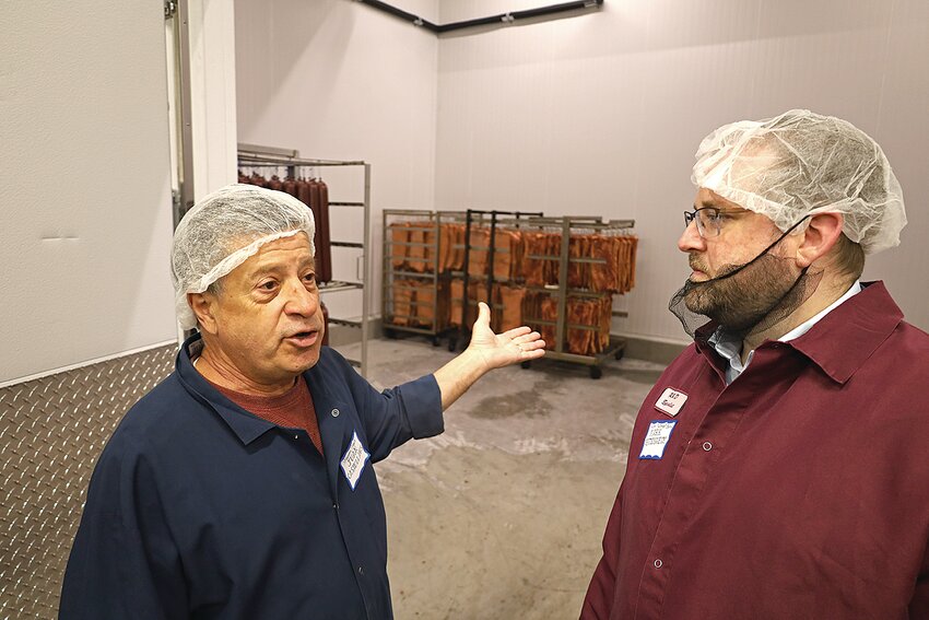Juan Castellanos, co-owner of Manea’s Meats (from left) visits with Mark Nettesheim, Falcon National Bank chief sales officer, during an April 25 building tour in downtown Sauk Rapids. Manea’s Meats received a $9.34 million food supply chain guaranteed loan from the U.S. Department of Agriculture to complete a 12,125-square-foot expansion to its facility.