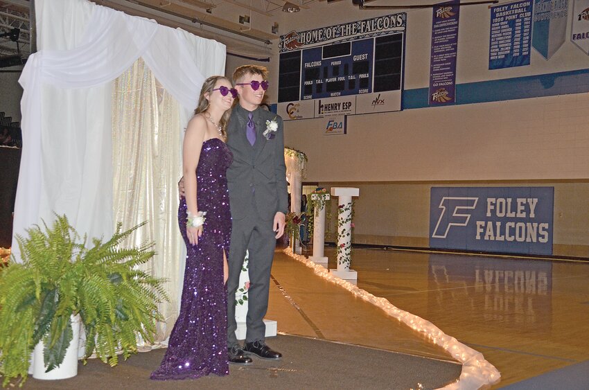 Megan Cielinski (left) and Riley Luberda pose and smile during the prom grand march May 11 at Foley High School in Foley. Students ate dinner and danced in Stillwater during the prom.