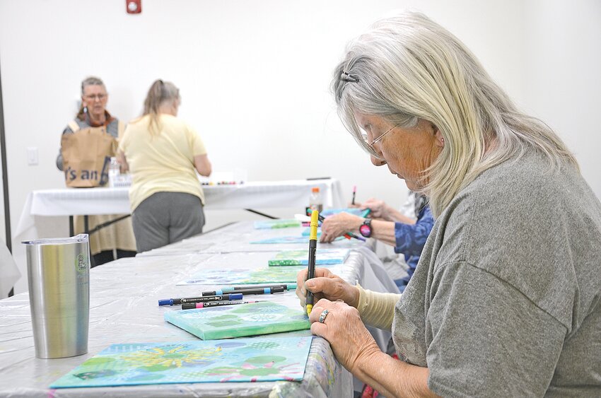 Julie Goenner adds final details to her artwork with a yellow marker May 6 in Foley. Community Action Respecting Elders hosted the art class for senior citizens in the greater Benton County community.