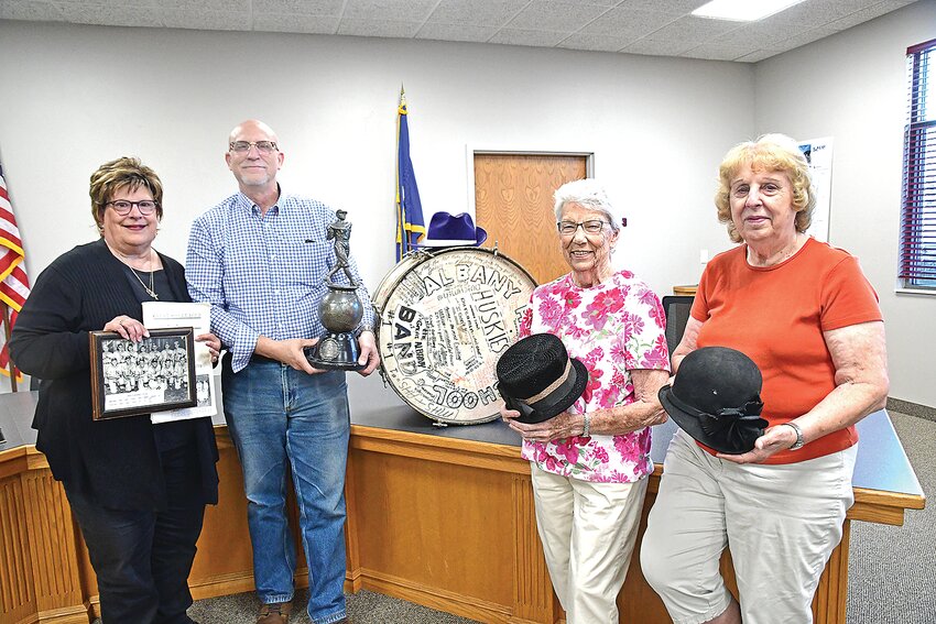Albany Area Heritage Society members — Peggy Kloos (from left), John Kloos, Ginny Meier and Shirley Bauer — display donated items July 16 at Albany City Hall in Albany. The Klooses are holding memorabilia from the Great Soo League.