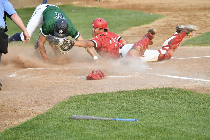 Sauk Rapids Cyclones catcher Jeff Solorz applies a tag to Sartell Muskies baserunner Adam Schellinger at home plate during a Sauk Valley League playoff game July 13 at St. Cloud Orthopedics Field in Sartell. Schellinger was called safe on the play.