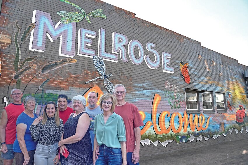 Mary Monroe (front, from left), Veronica Botello, Barb Dettler and Nancy Muenchow; (back, from left) Ron Barten, Jose Botello, Tim Petermeier and Mark Muenchow gather Sept. 12 in front of the Melrose Bakery wall they helped paint in Melrose. Not pictured were painters Amy Fuechtmann, Dottie Pallansch, Jim Holthaus, Joyce Westendorf, Autumn Dettler and Liz Pohlmann.