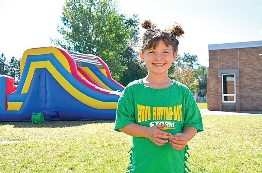 Tinley Althaus displays a wide grin while waiting in line for a bounce house Sept. 20 at Rice Elementary School in Rice. For the second consecutive year, the Rice Elementary School Parent Teacher Advisory Board hosted the homecoming celebration for pre-K through fifth grade students.