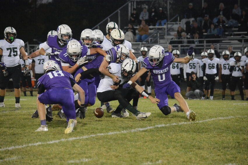 Albany defenders go after a loose ball against Rockford Oct. 4 at Michael Field at Herges Stadium in Albany. The Huskies would recover the fumble, with Connor Plumski, Jake Buttweiler, Braeden Justin, Ethan Meyer and Cooper Brinkman being among those who pounced on the ball.