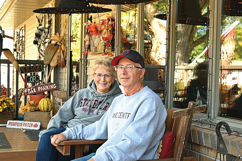 Tim Soule and his wife, Beverly, sit together on the front porch of their home Oct. 4 in Sauk Centre. The Soules have been decorating their yard for holidays throughout the year with the hope it brings joy to others.