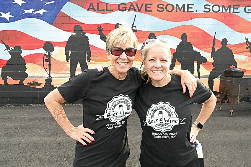 Laurie Burgman (left) and Kim Coday gather together after running through Sinclair Lewis Park in Sauk Centre Oct. 5 for the American Legion Post 67 Beer & Wine Run, Walk & Stumble 5K. Friends Coday and Burgman are on a journey together to complete a run in all 50 states; the run in Sauk Centre was No. 42 on their list.