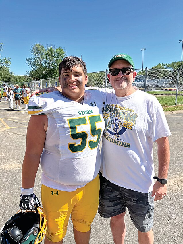 Sauk Rapids-Rice senior offensive lineman Hayden Brown celebrates a season-opening Storm win with his father, John, Aug. 30 at Irondale High School in New Brighton. John passed away suddenly while golfing Sept. 18.