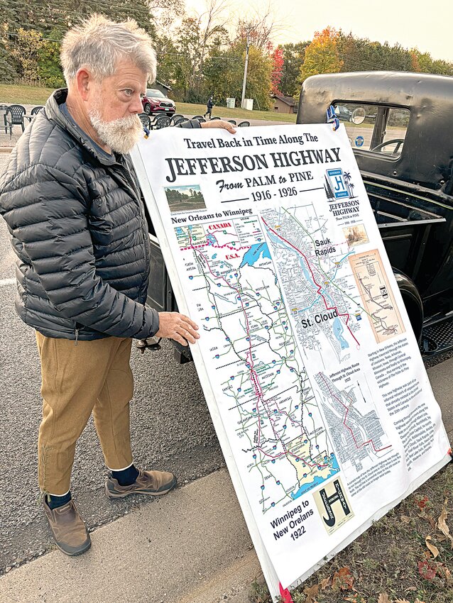 Sauk Rapids resident Jasper Bond listens to a question about a Jefferson Highway interpretative map Oct. 5 prior to the arrival of a Military Vehicle Preservation Association convoy stop in St. Stephen. Bond and members of the Mid-State A’s classic car club served as vehicular ambassadors at the community event.