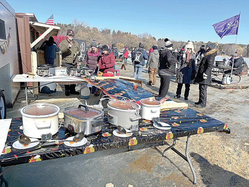 Slow cookers filled with steaming hot chili await attendees prior to the March 1 start of the fifth annual Little Rock Lake Chilly Games near Benton Beach Campground in rural Rice. Many attendees reported ice depths approaching 30 inches; fire pits were set up to keep participants warm, and a fish house was converted to a shelter.