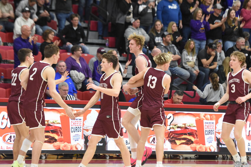 Matthew Zenzen (left) and Adam Neubert (right) guard Melrose’s Teague Dusha during the playoff game March 8 at St. John’s University in Collegeville. Sauk Centre won the game by six points.