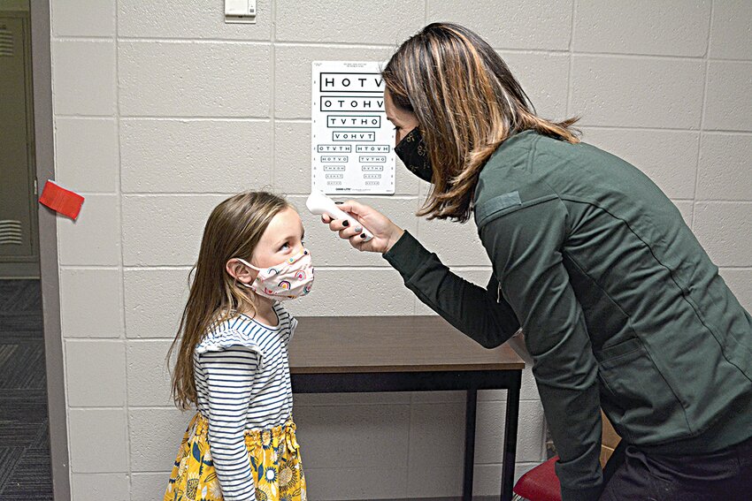 Distirct nurse Amanda Pflipsen checks her daughter’s temperature Aug. 20, 2020, at Hillside School in Sauk Rapids. The first Benton County case of COVID-19 was reported to public health five years ago on March 15, 2020.